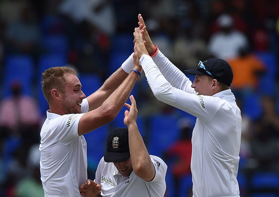 The high five: James Tredwell goes underneath the celebration of Stuart Broad and Joe Root