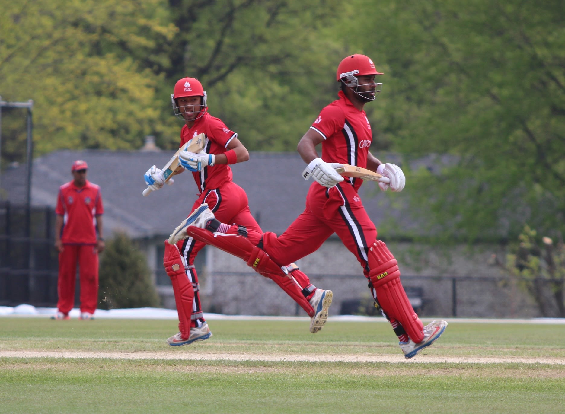 Nitish Kumar (l) and Ruvindu Gunasekera (r) run between the wickets