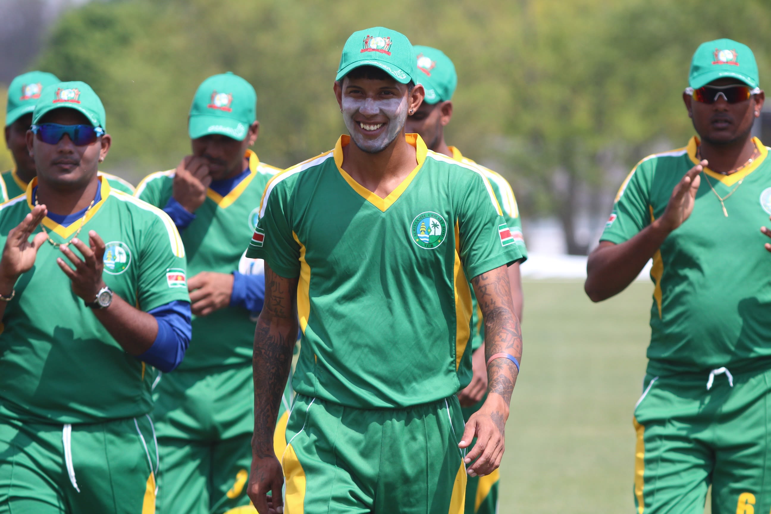 Muneshwar Patandin is applauded off the field after taking six wickets
