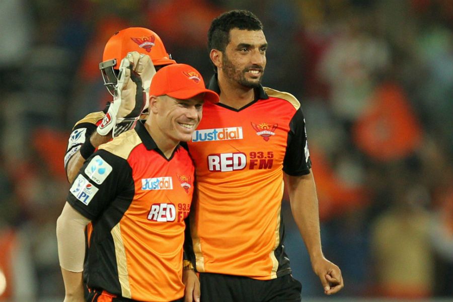 Bipul Sharma and David Warner celebrate a wicket