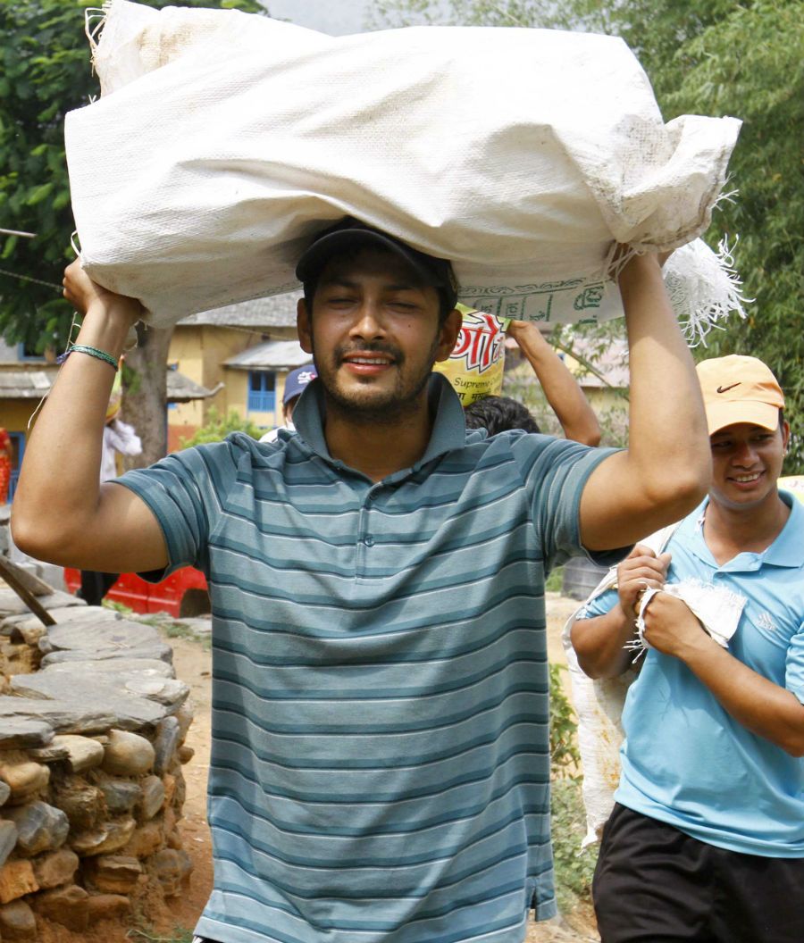 Subash Khakurel, wicket keeper batsman of the Nepal national cricket team carrying relief material to earthquake victims at Baseshwor VDC in Sindhuli on May 7 2015.