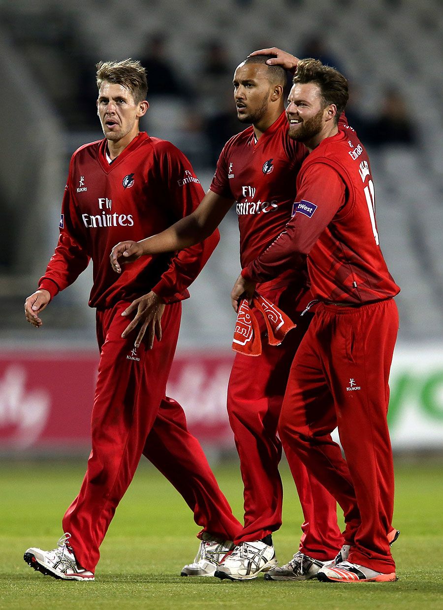 George Edwards (centre) took four wickets on his first appearance for Lancashire
