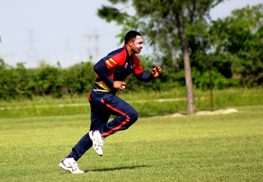 Adam Sanford runs in to bowl in Texas