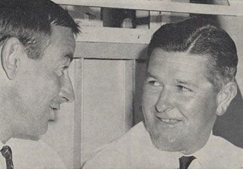 Ian Meckiff (left) confers with umpire Colin Egar in the pavilion at Brisbane. Egar had no-balled him four times for throwing in his first - and only - over