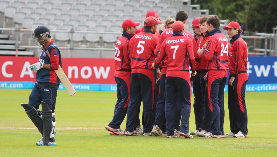 The Jersey players celebrate the dismissal of Binod Bhandari