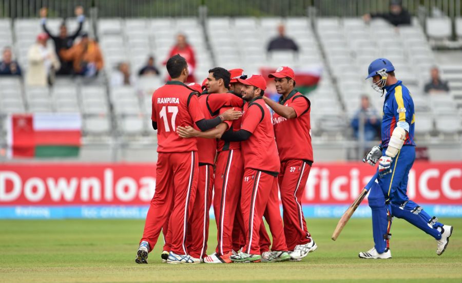 Ajay Lalcheta is mobbed by his team-mates after dismissing Gerrie Snyman