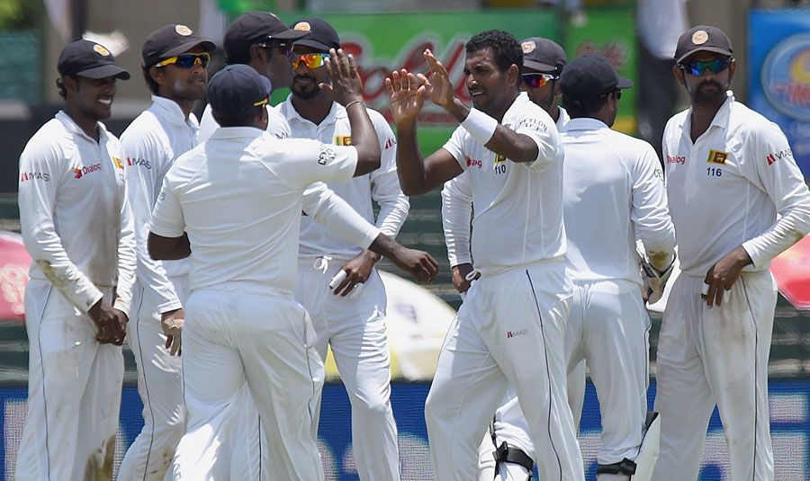 Dhammika Prasad celebrates the wicket of Rohit Sharma