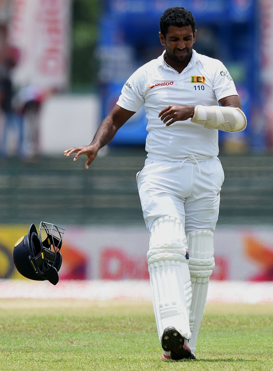 Dhammika Prasad winces after being struck on his arm