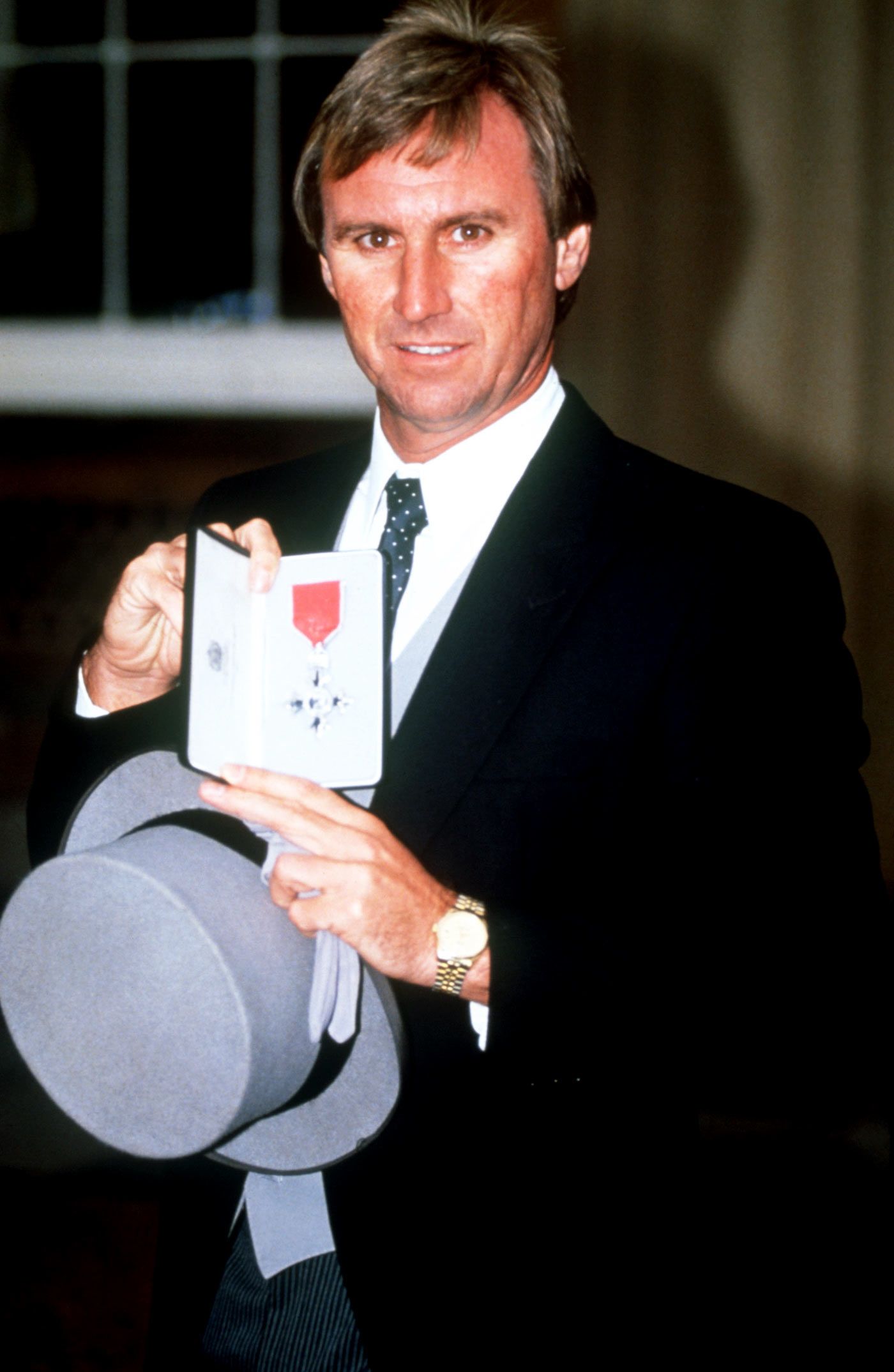 John Lever poses with his MBE