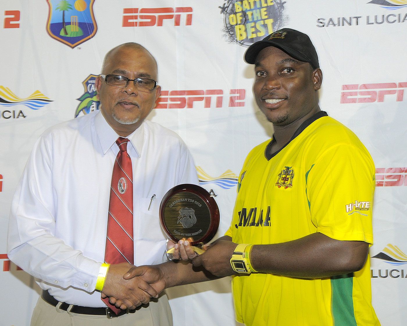 Trinidad & Tobago Cricket Board president Azim Bassarath presents an award to Tamar Lambert