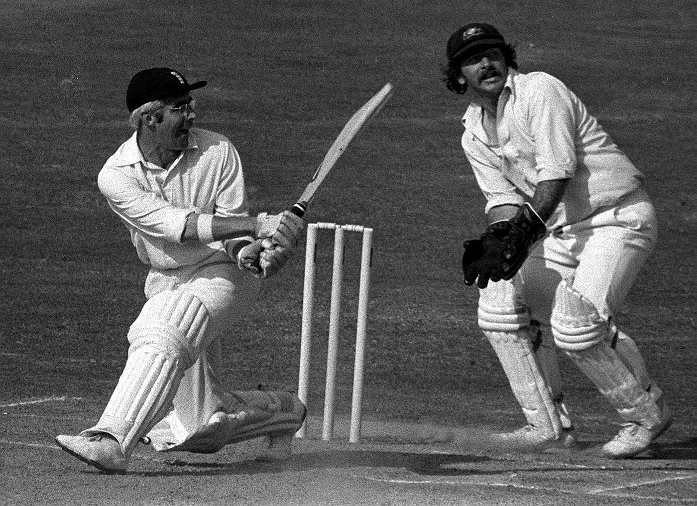 David Steele sweeps as Rod Marsh looks on
