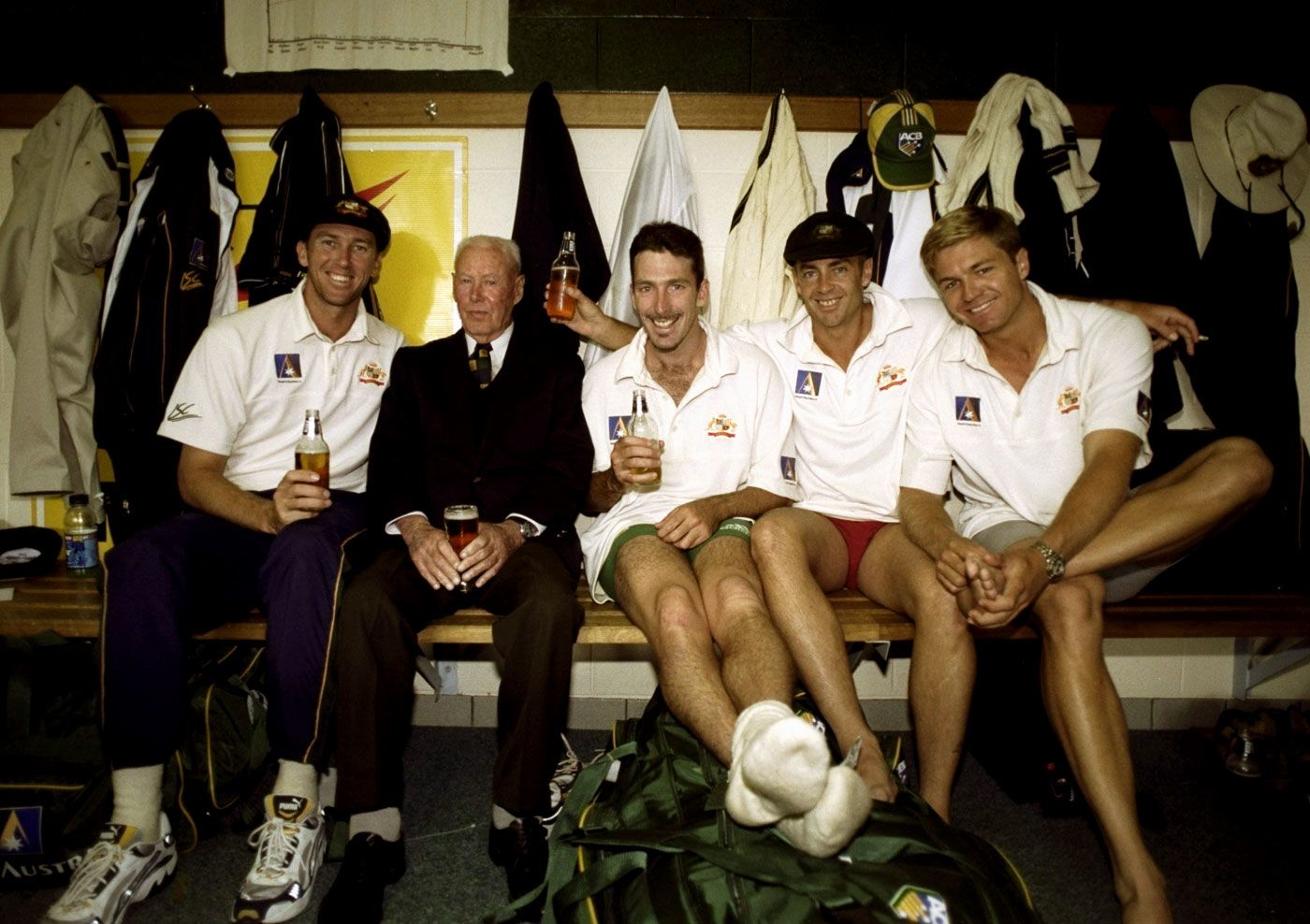 Invincible Bill Brown shares a beer with Australian players in the dressing room in Hobart
