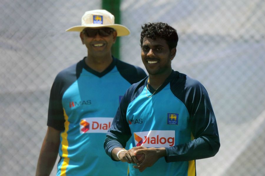 Tharindu Kaushal prepares to bowl under the watchful eyes of coach Jerome Jayaratne