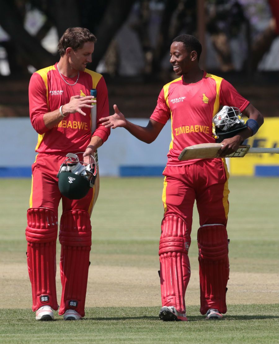 Craig Ervine and Tinotenda Mutumbodzi walk off after securing the eight-wicket win