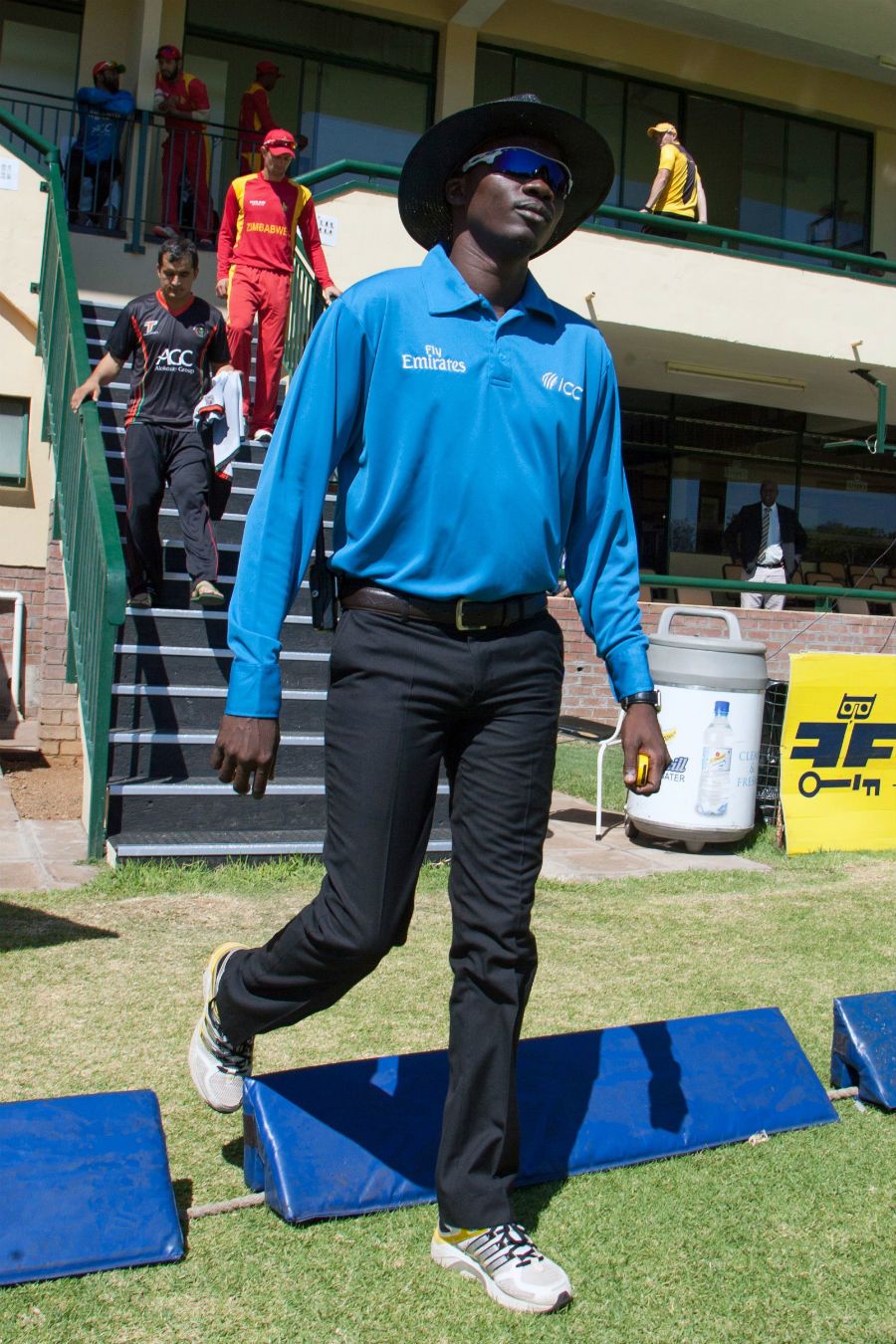 Umpire Langton Rusere walks in for his international debut