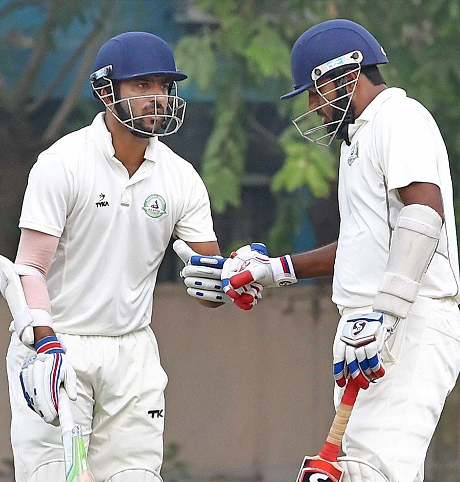 Wasim Jaffer taps his glove with Faiz Fazal after getting to 10,000 runs in Ranji Trophy