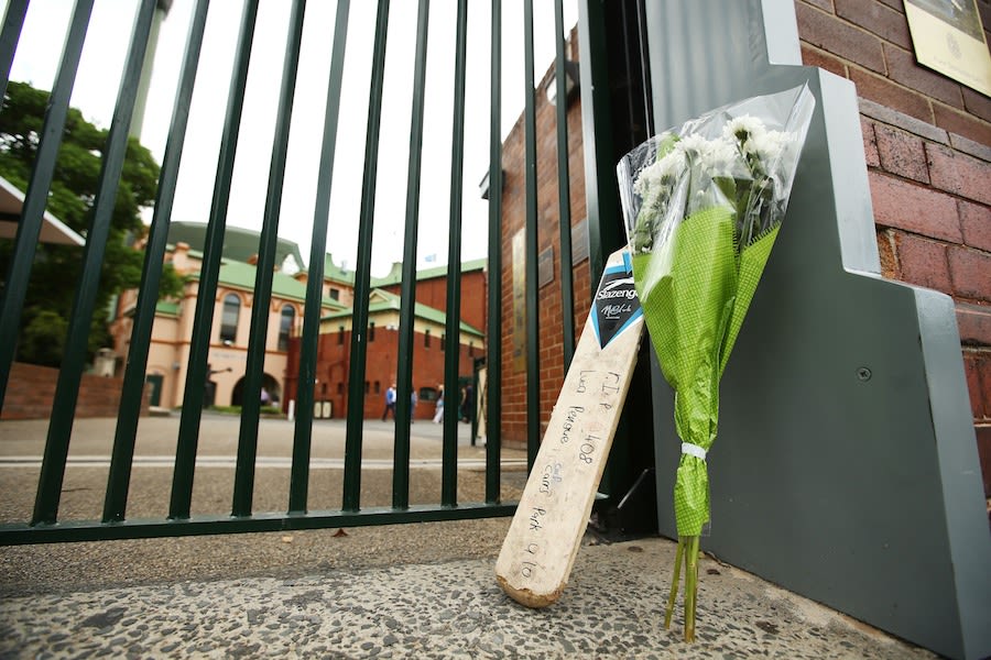 A bat and a bouquet left outside the SCG in tribute to Phillip Hughes