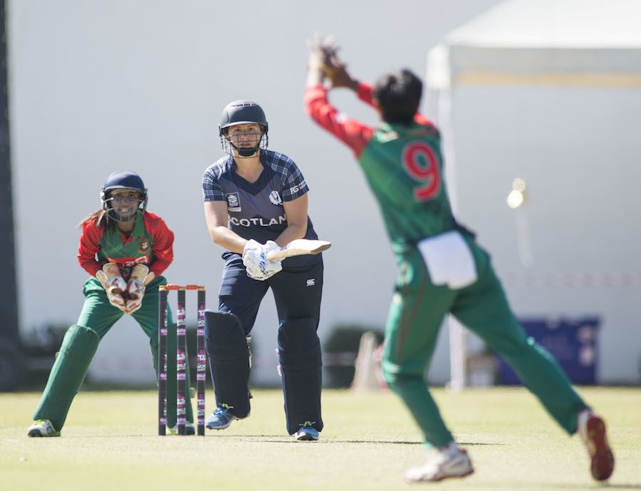 Fiona Urquhart strikes the ball back to Fahima Khatun