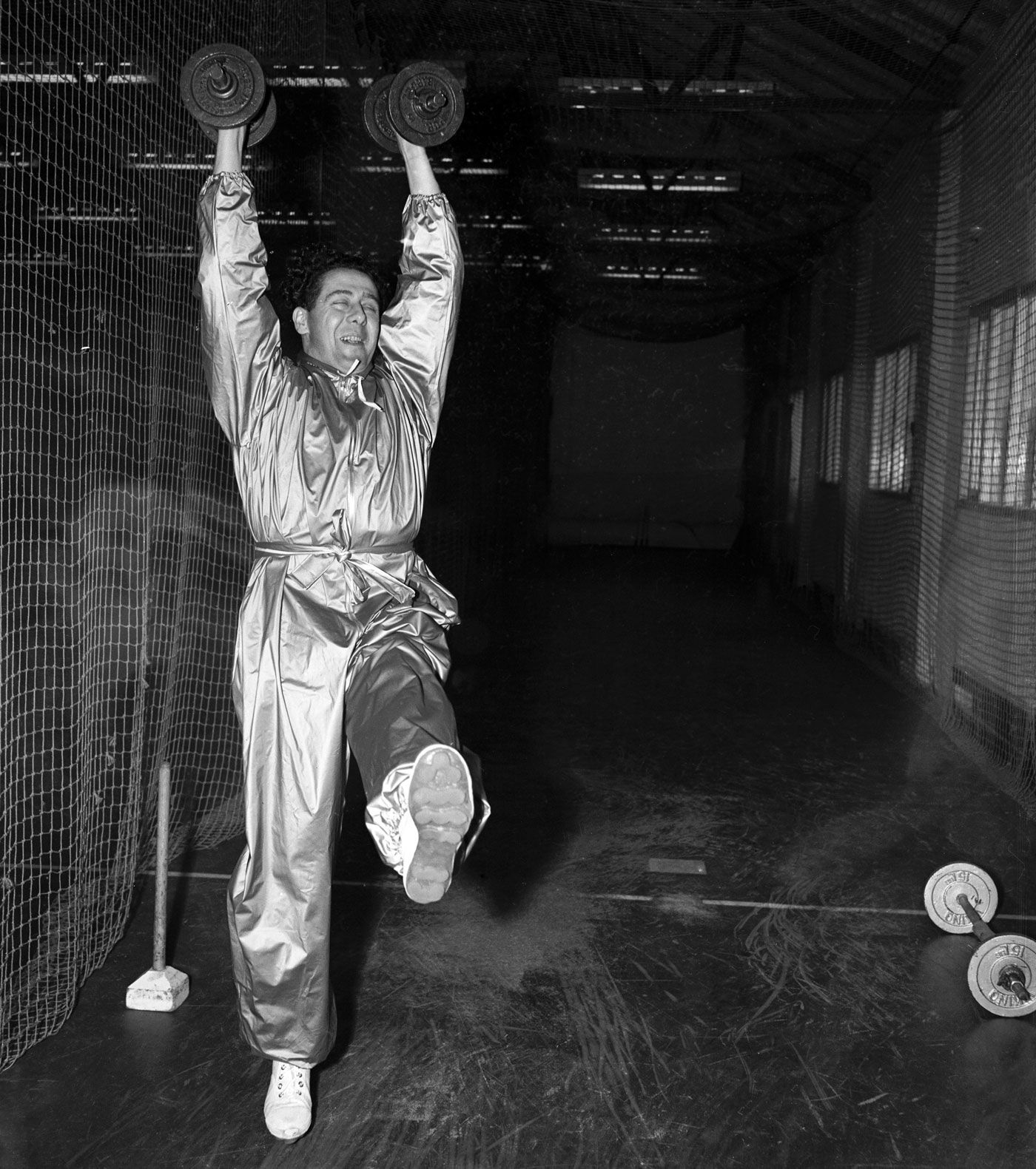 Trevor Bailey exercises while wearing a high-grade plastic sweatsuit designed to help him reduce weight