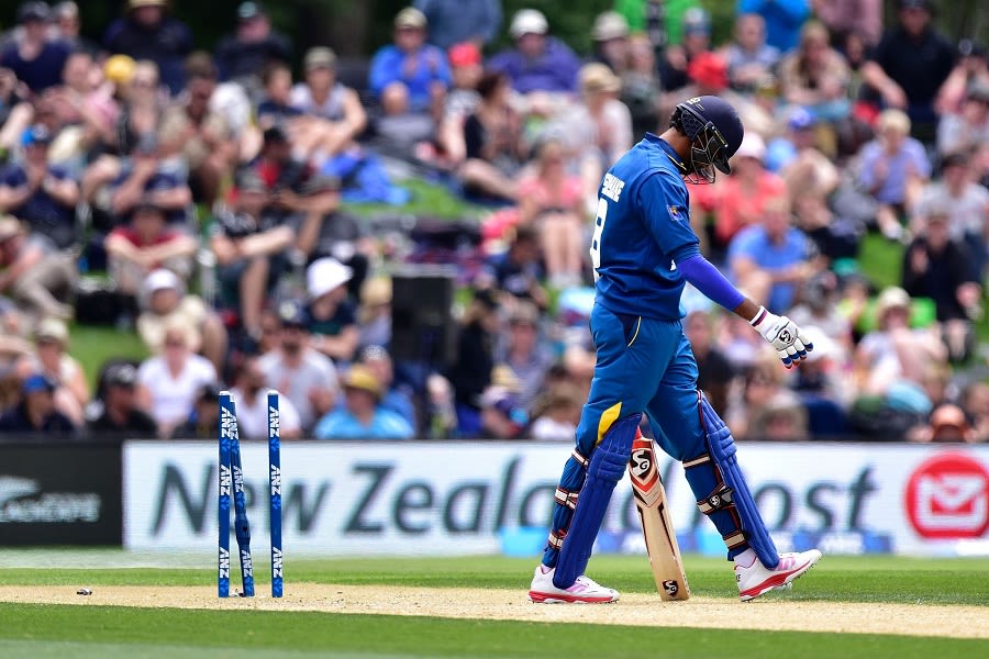 Sachithra Senanayake begins to walk back after being dismissed for a duck