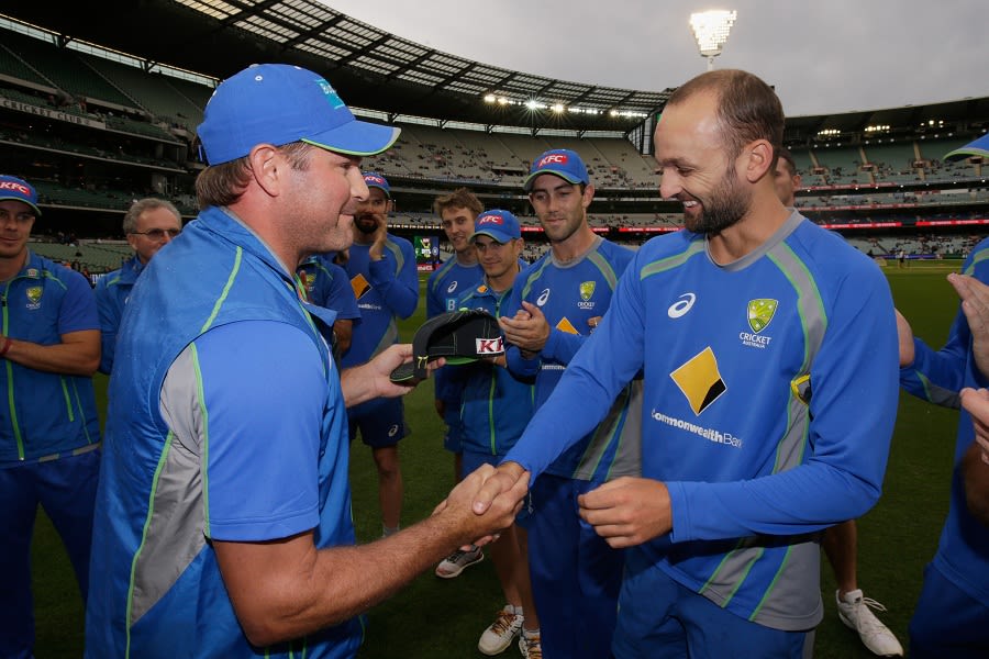Nathan Lyon is handed his Australia T20I cap by Ryan Harris