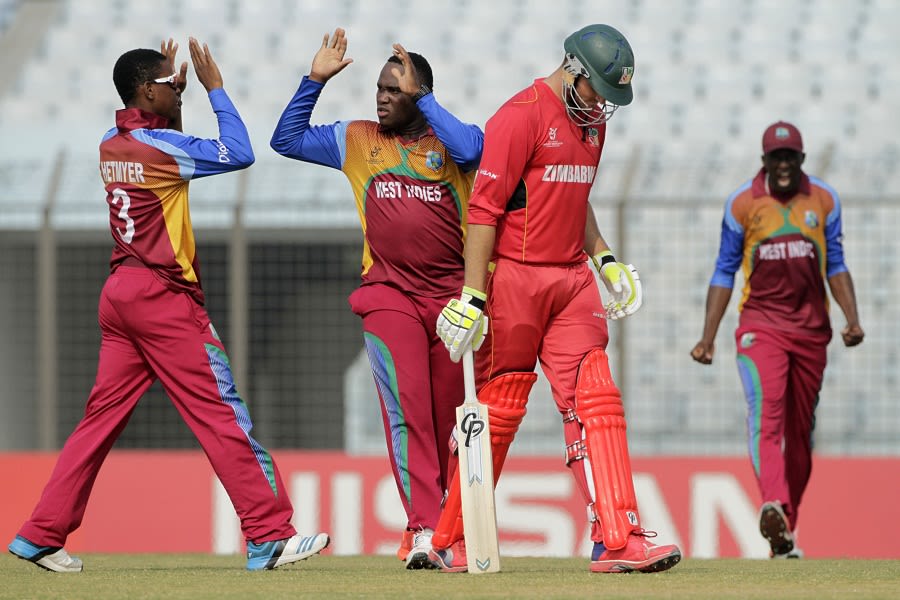 Gidron Pope celebrates a wicket with captain Shimron Hetmyer