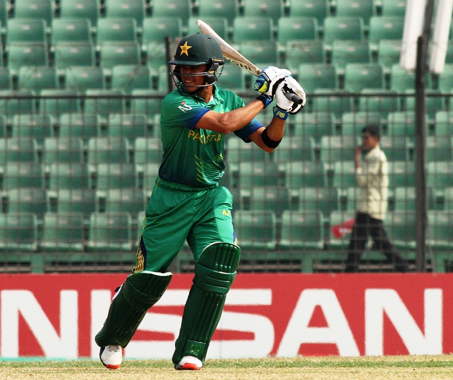 Umair Masood plays through the off side during his century