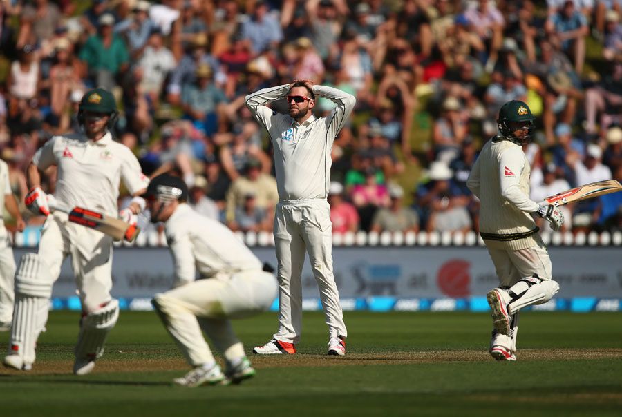 Mark Craig reacts to a chance as Steven Smith and Usman Khawaja complete a run