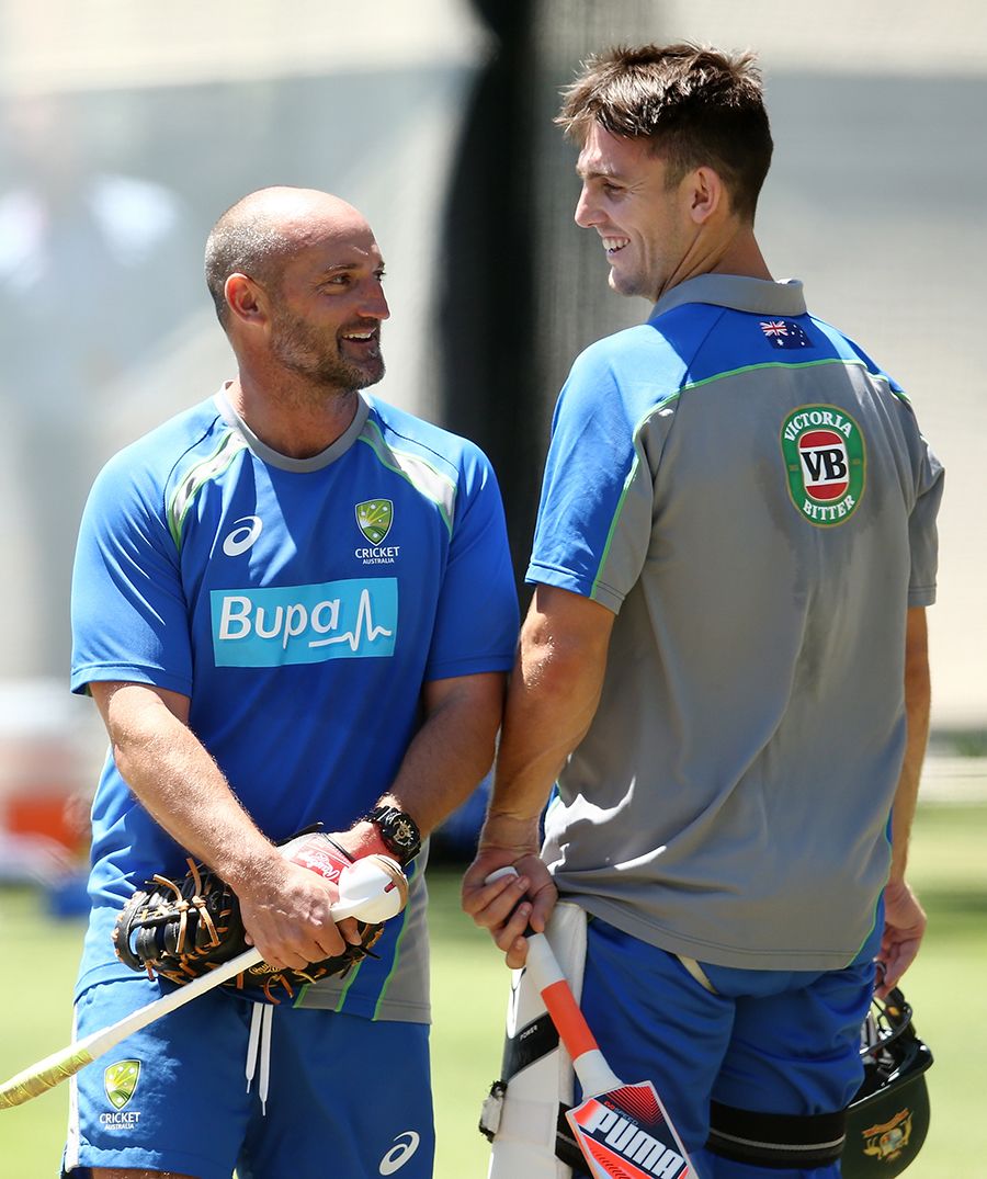 Michael Di Venuto speaks to Mitchell Marsh during a net session