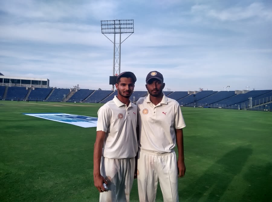 Prerak Mankand and Hardik Rathod pose after the second day's play