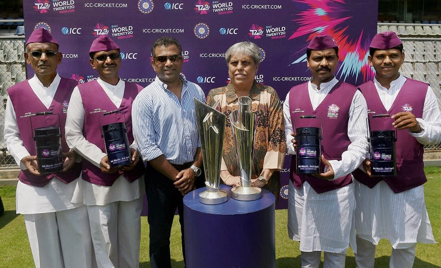 Former India cricketers Sameer Dighe and Diana Edulji and Mumbai dabbawalas pose with the World T20 trophies