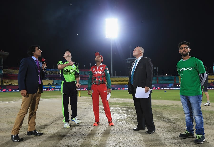 William Porterfield tosses the coin as Sultan Ahmed looks on