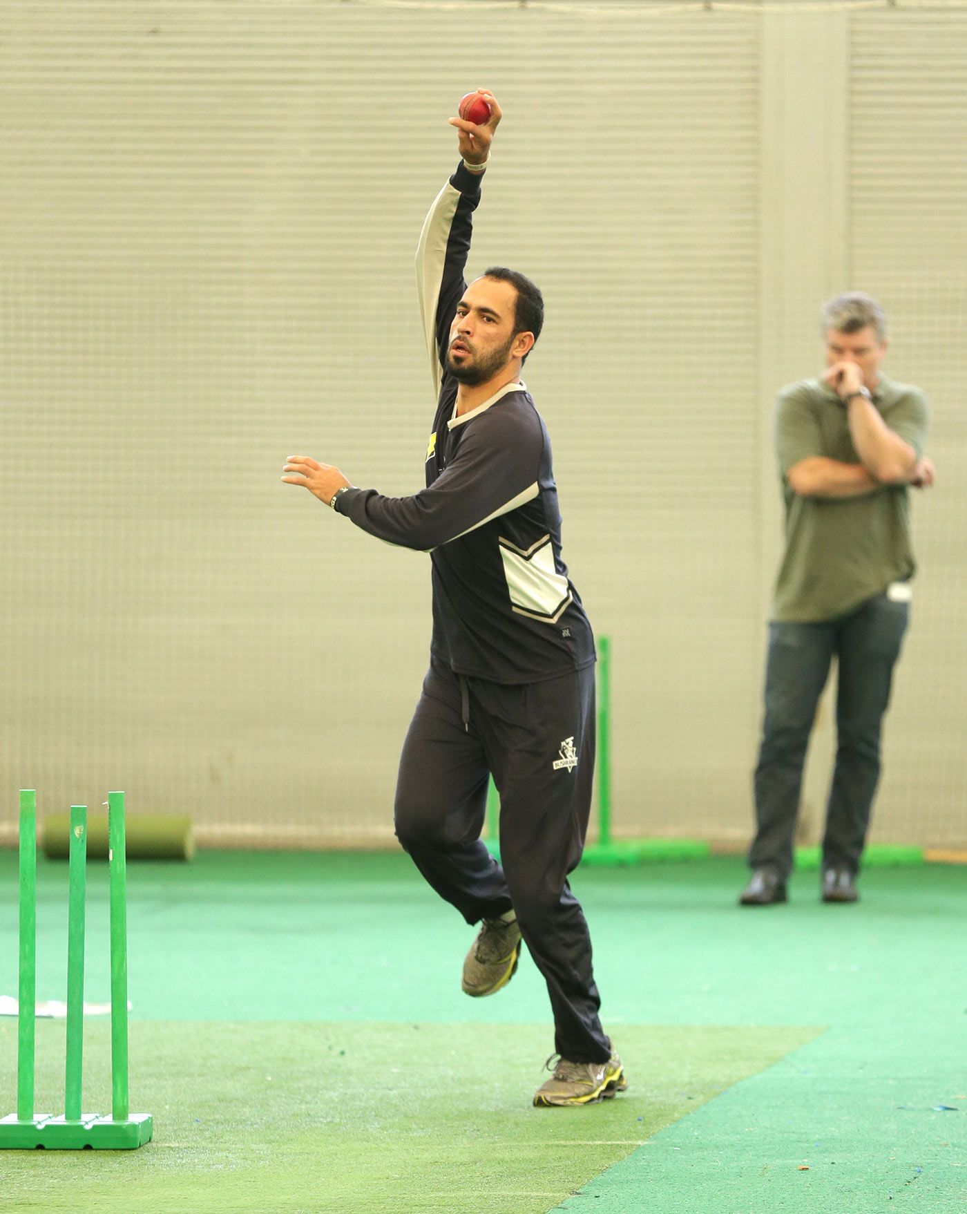Fawad Ahmed bowls in the nets as Stuart MacGill looks on