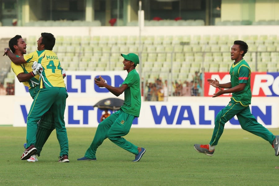 Muktar Ali is mobbed by his team-mates after sealing his side's tense win