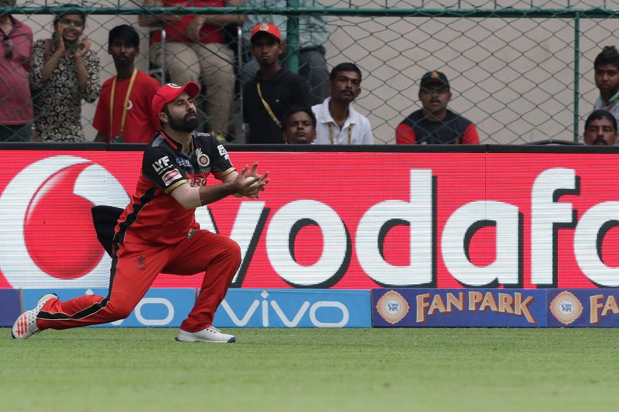 Parvez Rasool takes a catch to dismiss MS Dhoni