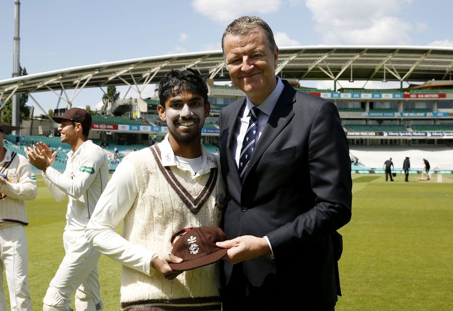 Arun Harinath receives his county cap from chairman Richard Thompson
