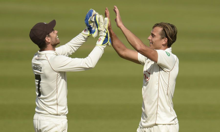 James Burke gets a high five from wicketkeeper Ben Foakes