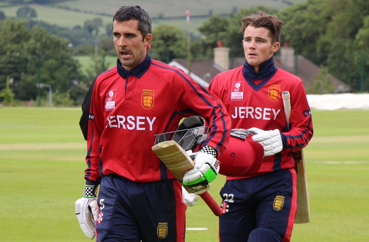 Jersey captain Peter Gough leads team-mate Jonty Jenner off the field after notching victory