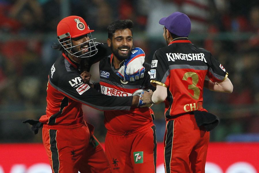 Iqbal Abdulla is mobbed by his team-mates after taking a wicket