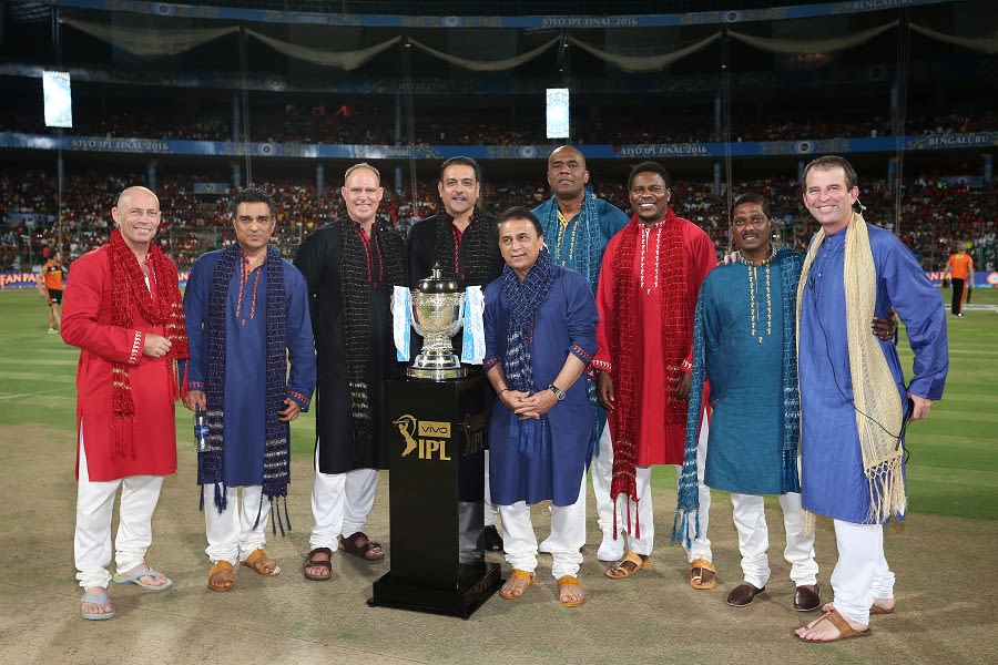 The commentary team for the final poses with the IPL trophy