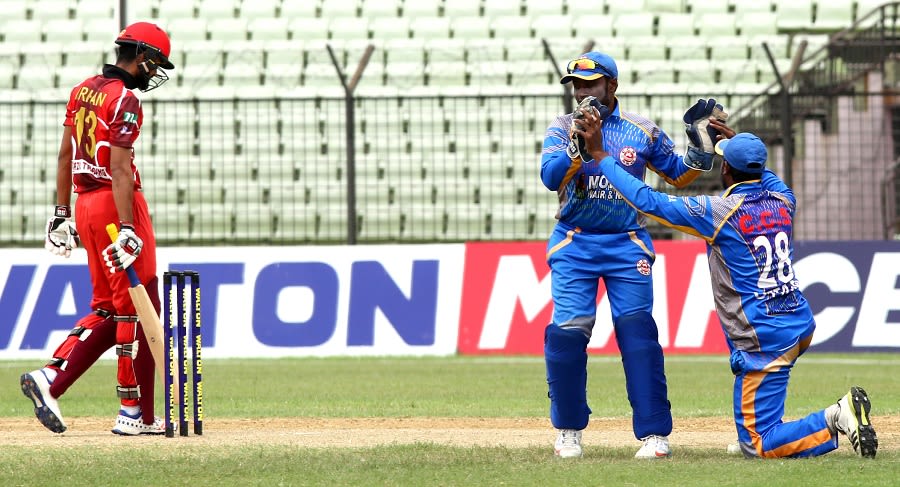 CCS wicketkeeper Ashrafun Nabi celebrates the dismissal of Irfan Sukkur with a team-mate