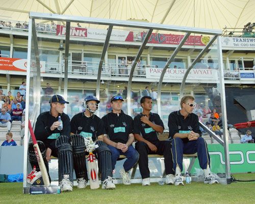 Hampshire players wait in the dugout