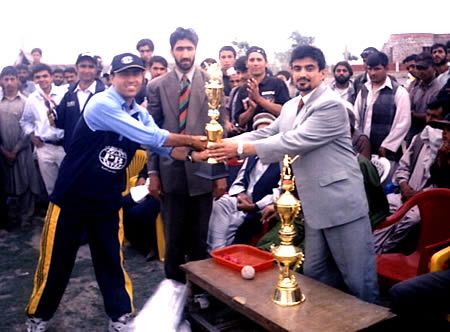Hasti Gul, PBCA captain receiving runners-up trophy from Mr Dashti of Afghan National Sports Committee as Allah Dad Noori, ACF president looks on