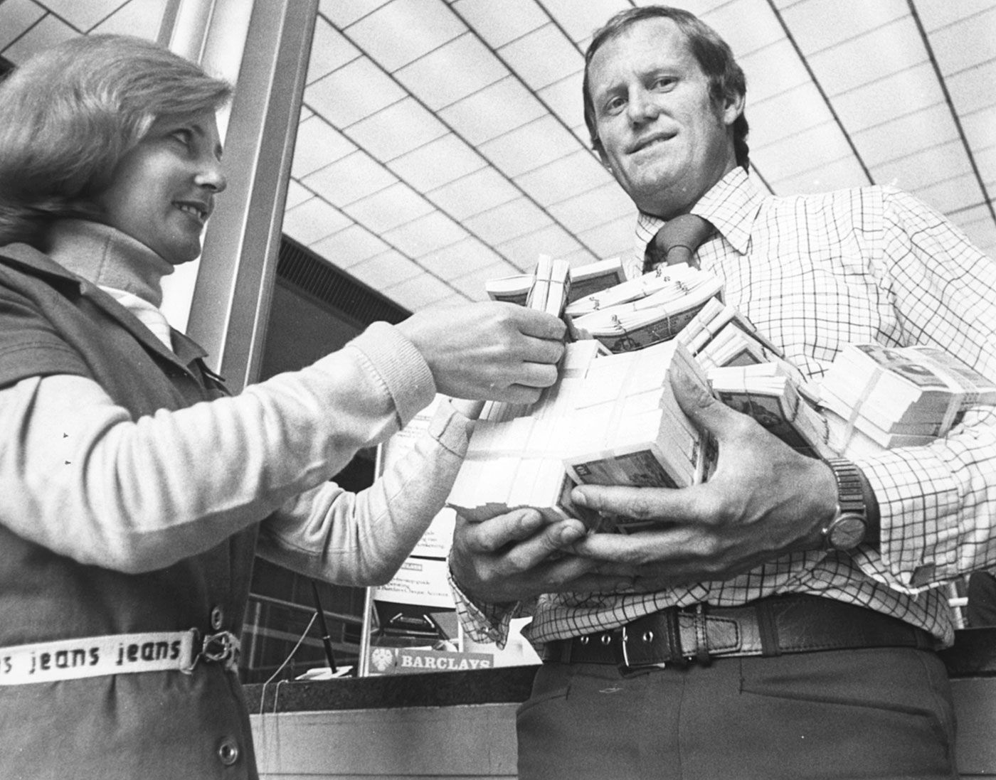 Graeme Pollock holds bundles of cash after signing for Kerry Packer's WSC
