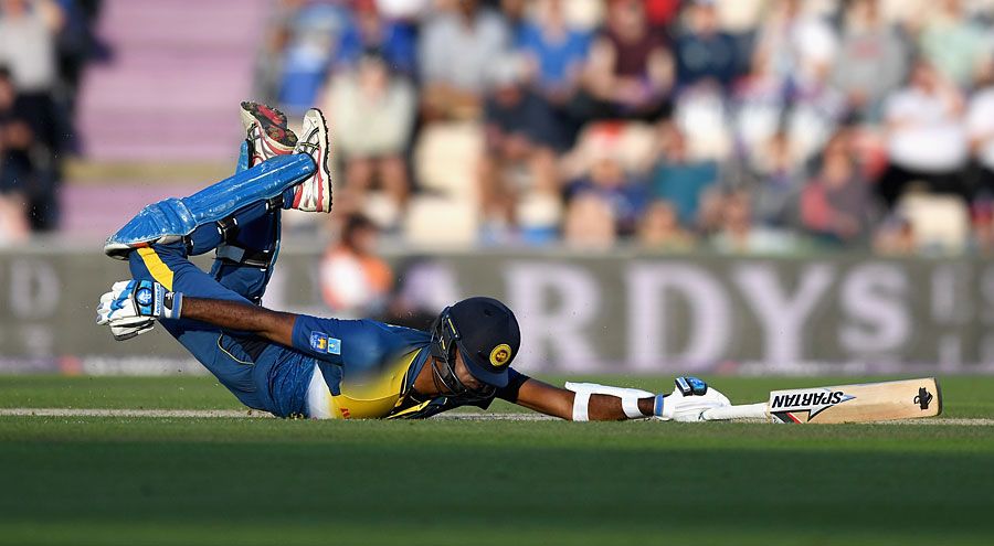 Farveez Maharoof dives to make his ground