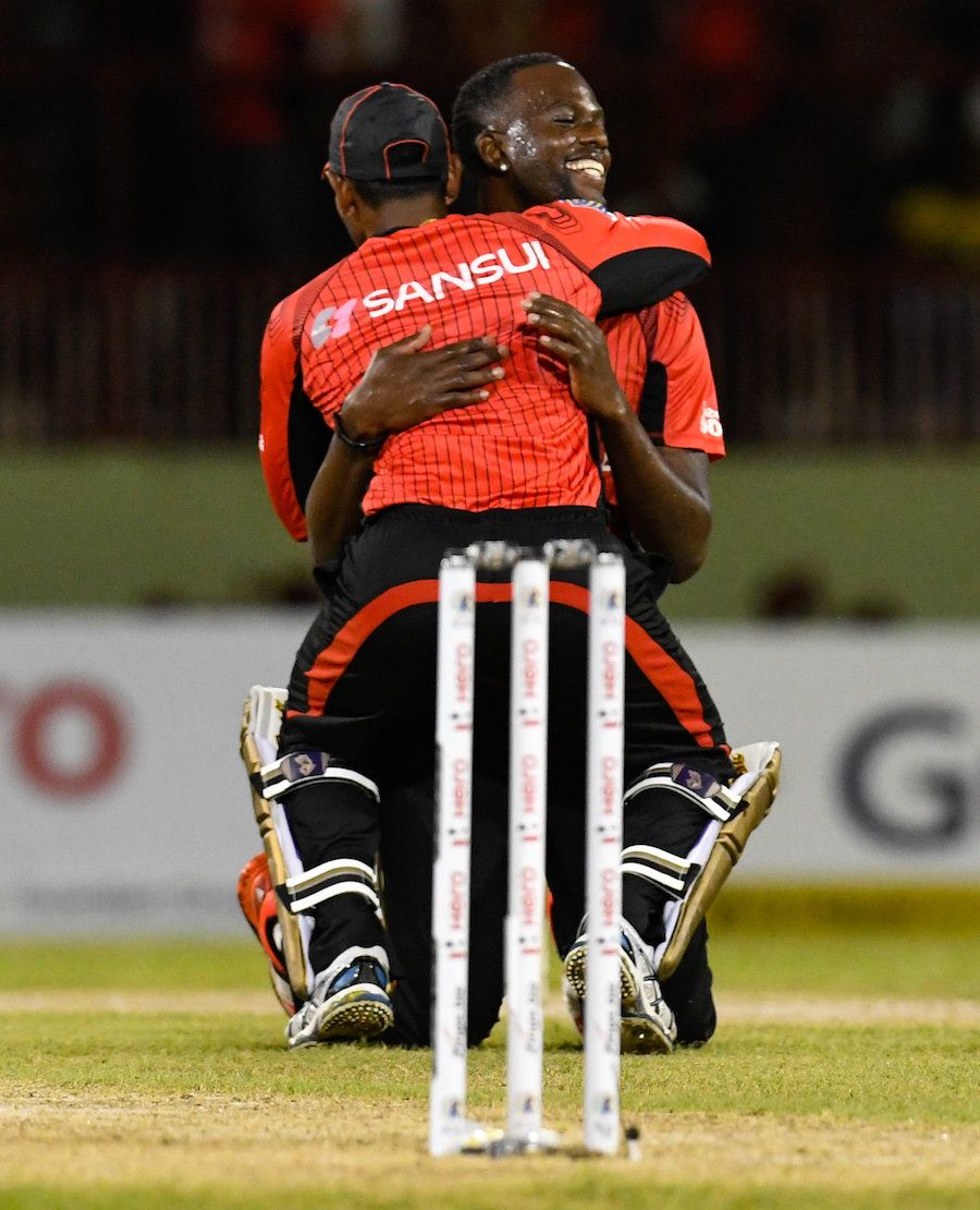 Kevon Cooper gets a hug from Denesh Ramdin after winning the match