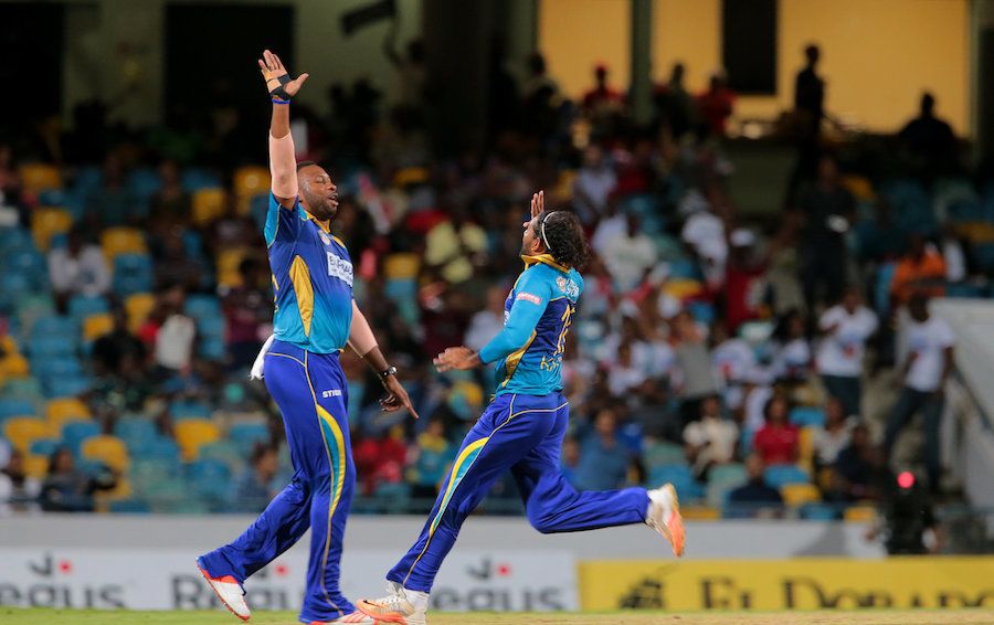 Kieron Pollard and Imran Khan celebrate the dismissal of Brad Hodge