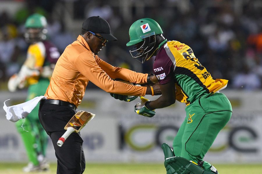 Umpire Leslie Reifer collides with Anthony Bramble