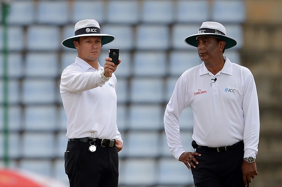 Umpire Richard Kettleborough draws out his light metre
