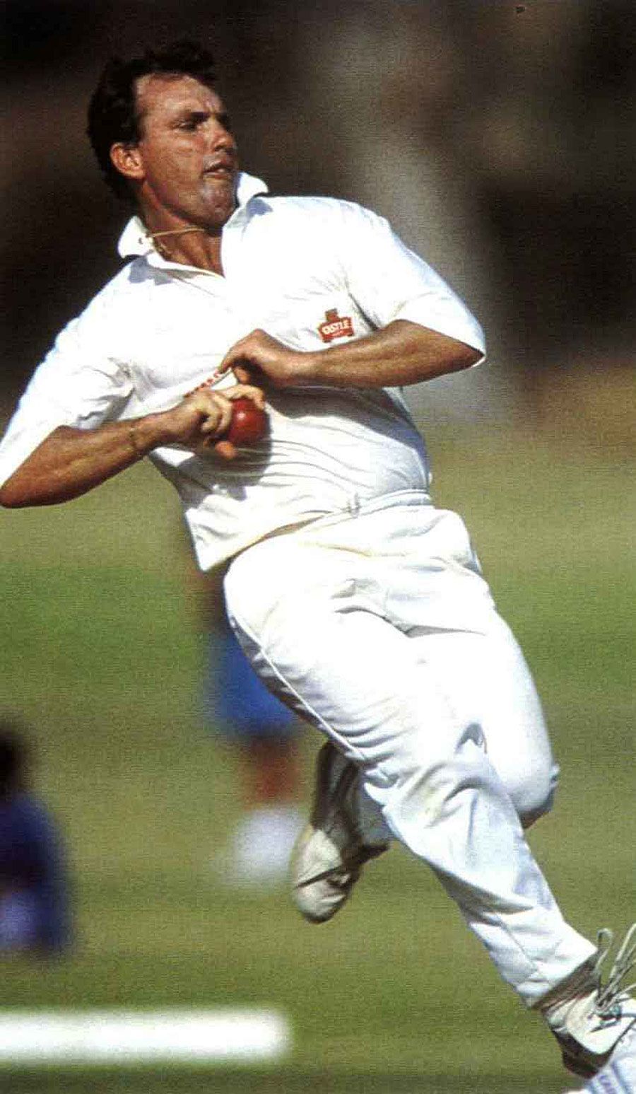 Dave Callaghan runs in to bowl